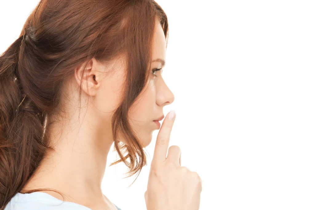 A side profile view of a woman with a straight, balanced nose achieved through Rhinoplasty Tip Reshaping.