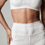 Patient exhibiting optimal abdominal wall contouring and skin retraction during the postoperative recovery phase of 360 liposuction.