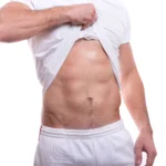 Male patient showcasing a firm, contoured abdomen after a Tummy Tuck for Men Dubai procedure.