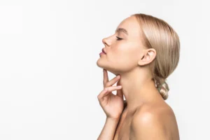 Profile view of a patient indicating the submental region and mandibular line for surgical assessment of Chin Liposuction in Dubai.