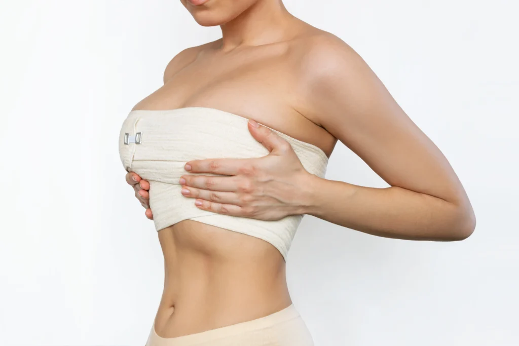 Application of medical-grade compression for edema management following Breast Augmentation in Dubai.