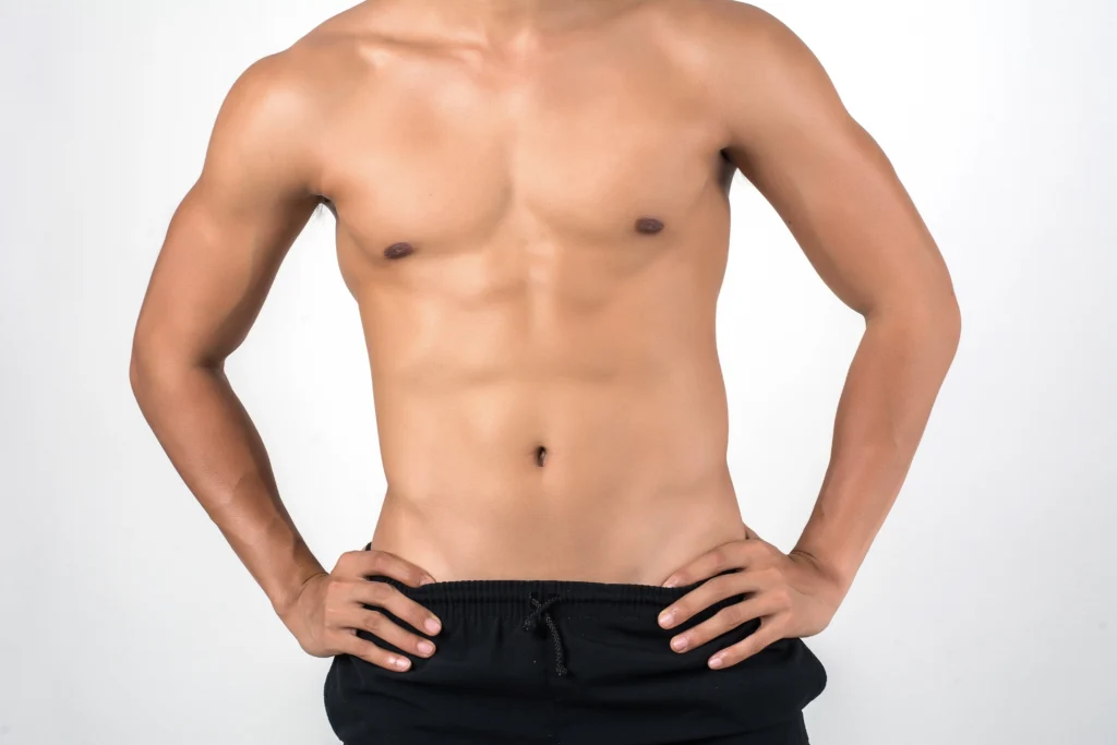 Anterior visualization of an athletic male patient presenting high-definition rectus abdominis inscriptions suitable for V Sculpt Liposuction in Dubai.