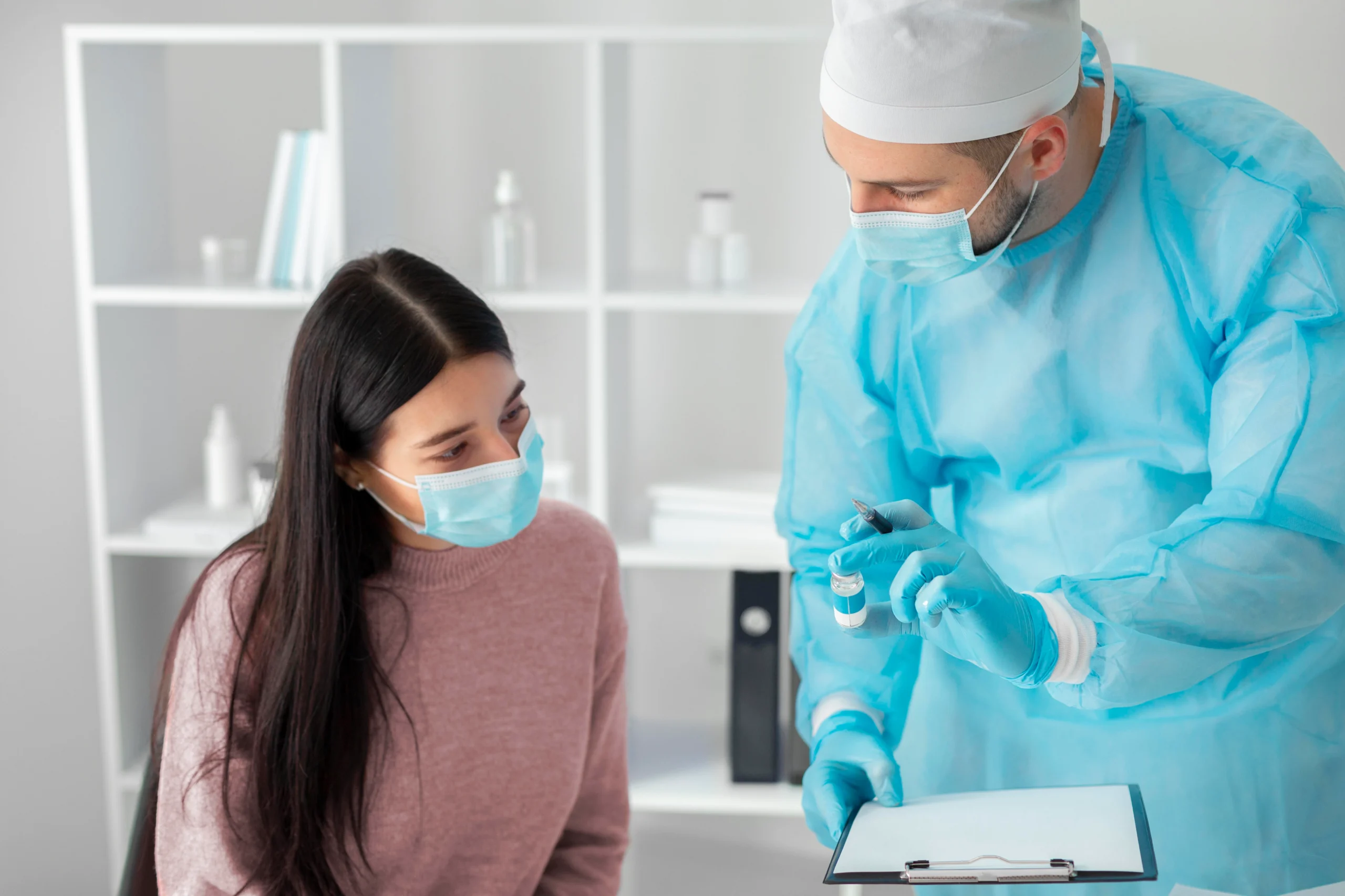 A close-up view of a plastic surgeon wearing blue scrubs and black surgical gloves reviewing clinical parameters and anatomical alignment metrics on a patient’s neck and jawline to explain How to choose a plastic surgeon in Dubai.